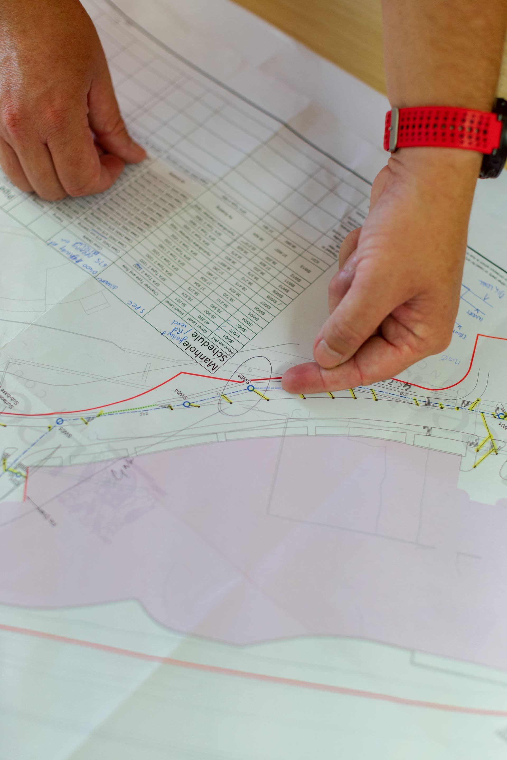 Engineer reviewing infrastructure route plans and schedules